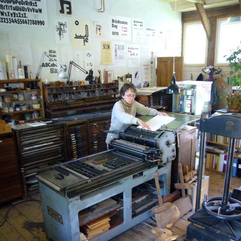 By the printing press at Grafikverkstan Godsmagasinet, the artist's own printing workshop outside of Köping in Sweden.